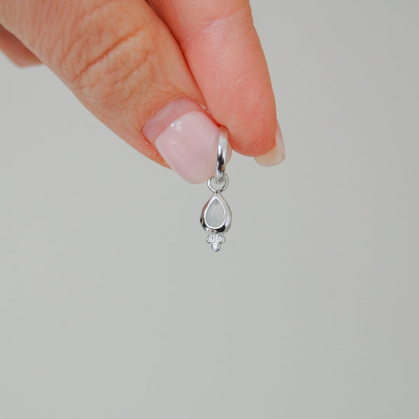 model hand showing the Moonstone & White Sapphire Tear Drop Hoop Earrings Sterling Silver