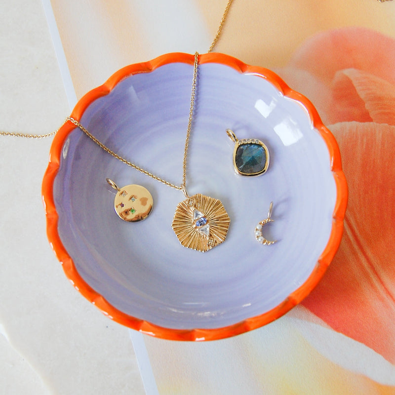 solid gold pendants in purple bowl including the Grecian Labradorite Stone Pendant 9k Gold