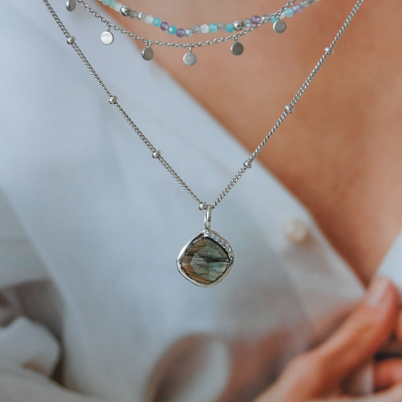 Grecian Labradorite Stone Pendant Sterling Silver hanging from a stationed bead silver chain