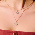 gold necklace on model in red dress