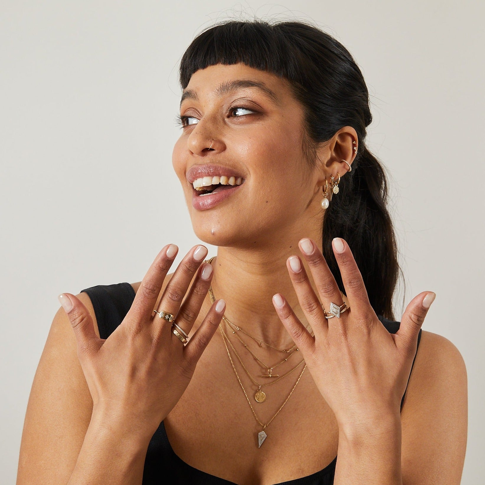 model wearing solid gold jewellery including the Diamond Starburst Ring 9k Gold