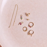 Diamond Threader Stud Earring 9k Gold along with other solid gold earrings on hard surface