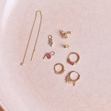 Diamond Threader Stud Earring 9k Gold along with other solid gold earrings on hard surface