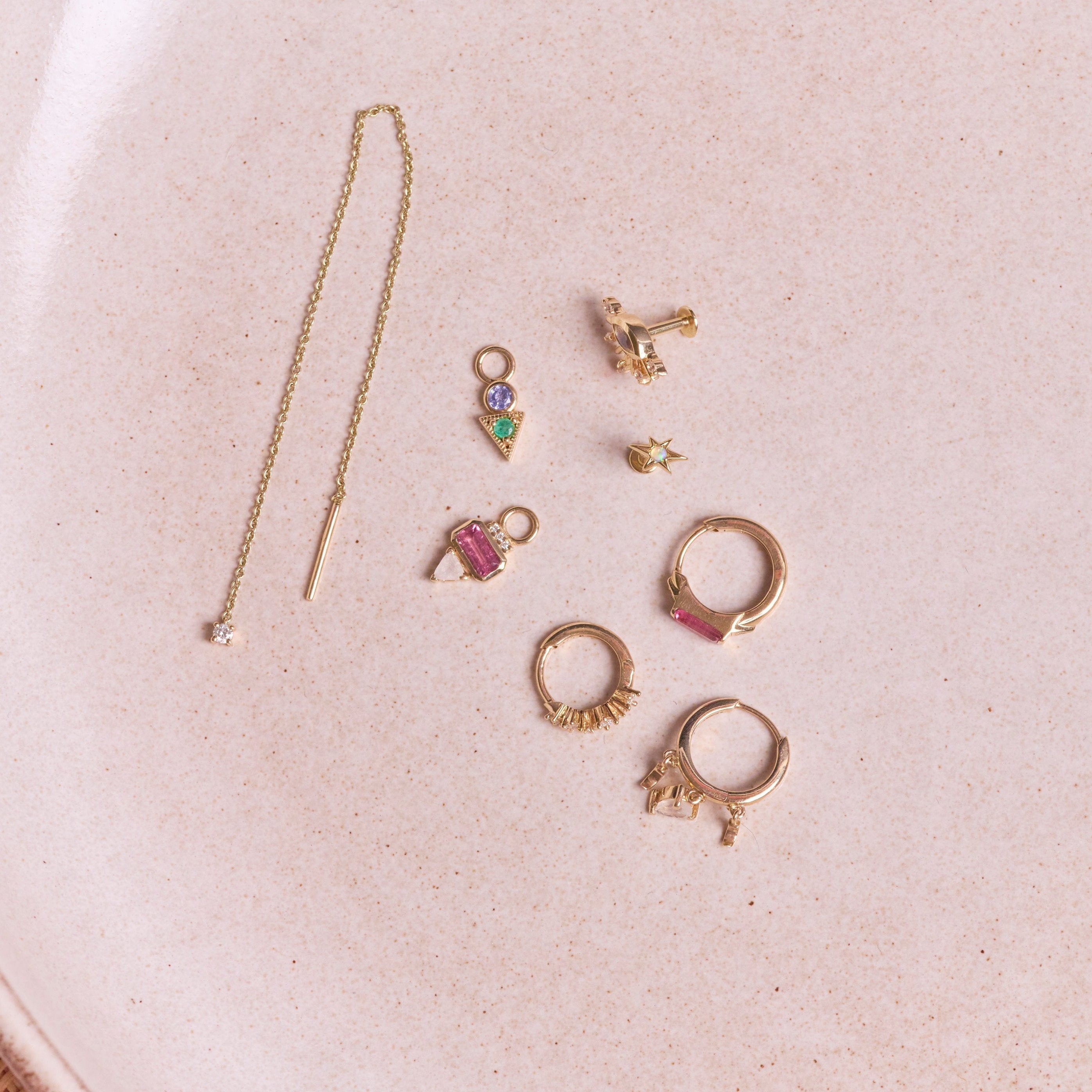 Diamond Threader Stud Earring 9k Gold along with other solid gold earrings on hard surface