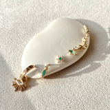 close up of solid gold ear stack including the Diamond & Emerald Flower Flat Back Earring 9k Gold