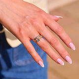 model hand showing solid gold ring stack including the Emerald Chain Ring 9k Gold