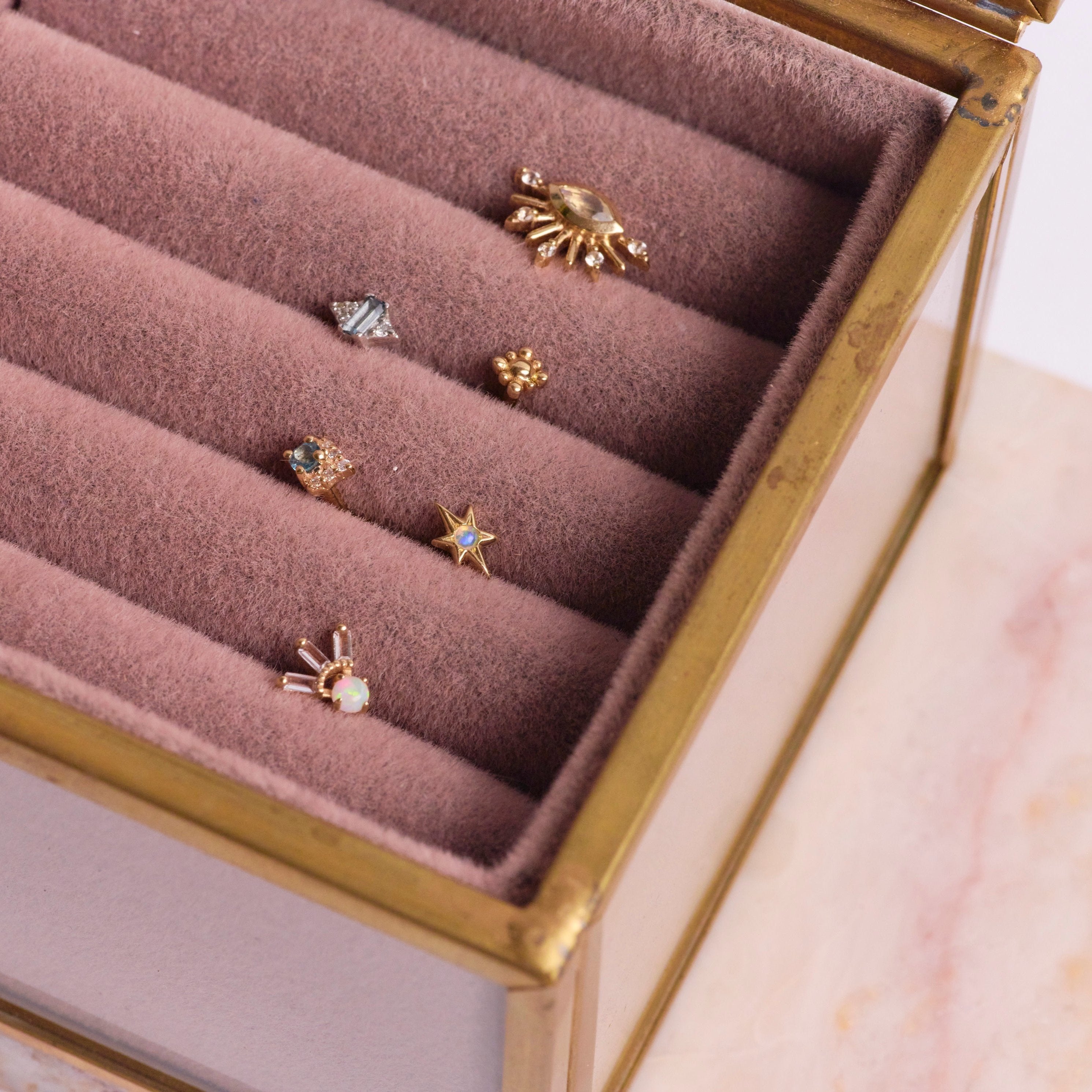 solid gold flat back collection in jewellery box including the London Blue Topaz & Diamond Arrow Flat Back 9k Gold