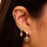 solid gold ear stack close up showing earrings including the Mini Diamond Beaded Huggie Hoop 9k Gold in upper helix