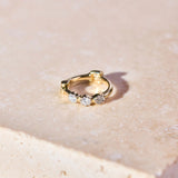 Mini Diamond Trilogy Huggie Hoop Earring 9k Gold on hard surface