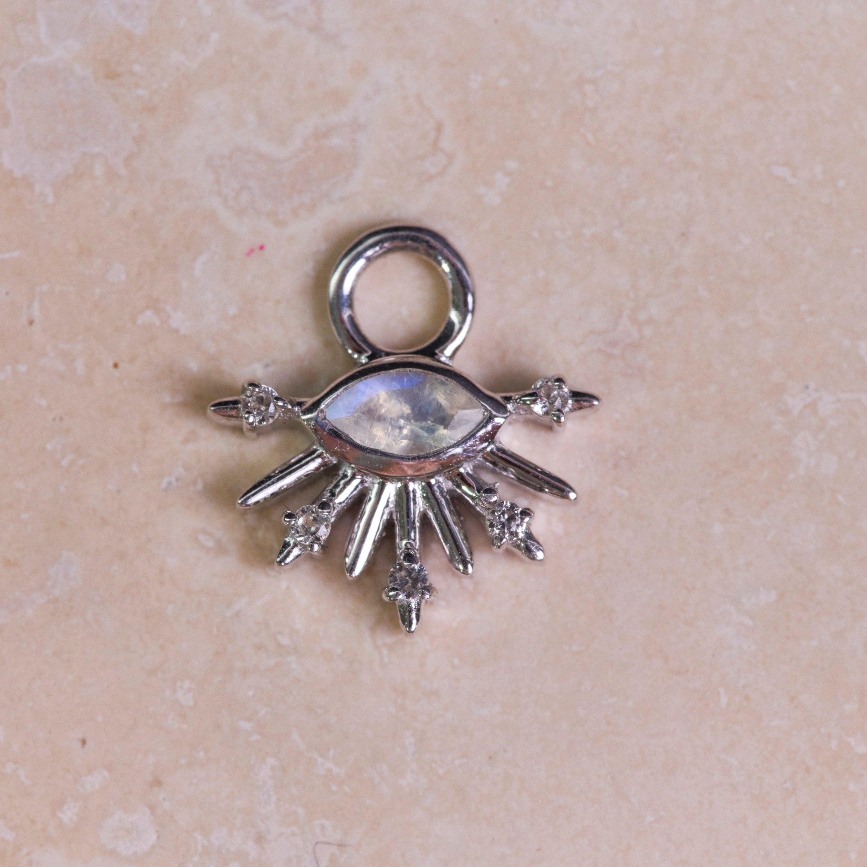 Moonstone & White Sapphire Sunburst Earring Charm Sterling Silver on hard surface