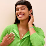 model wearing solid gold pieces including the Moonstone & White Sapphire Sunburst Necklace 9k Gold