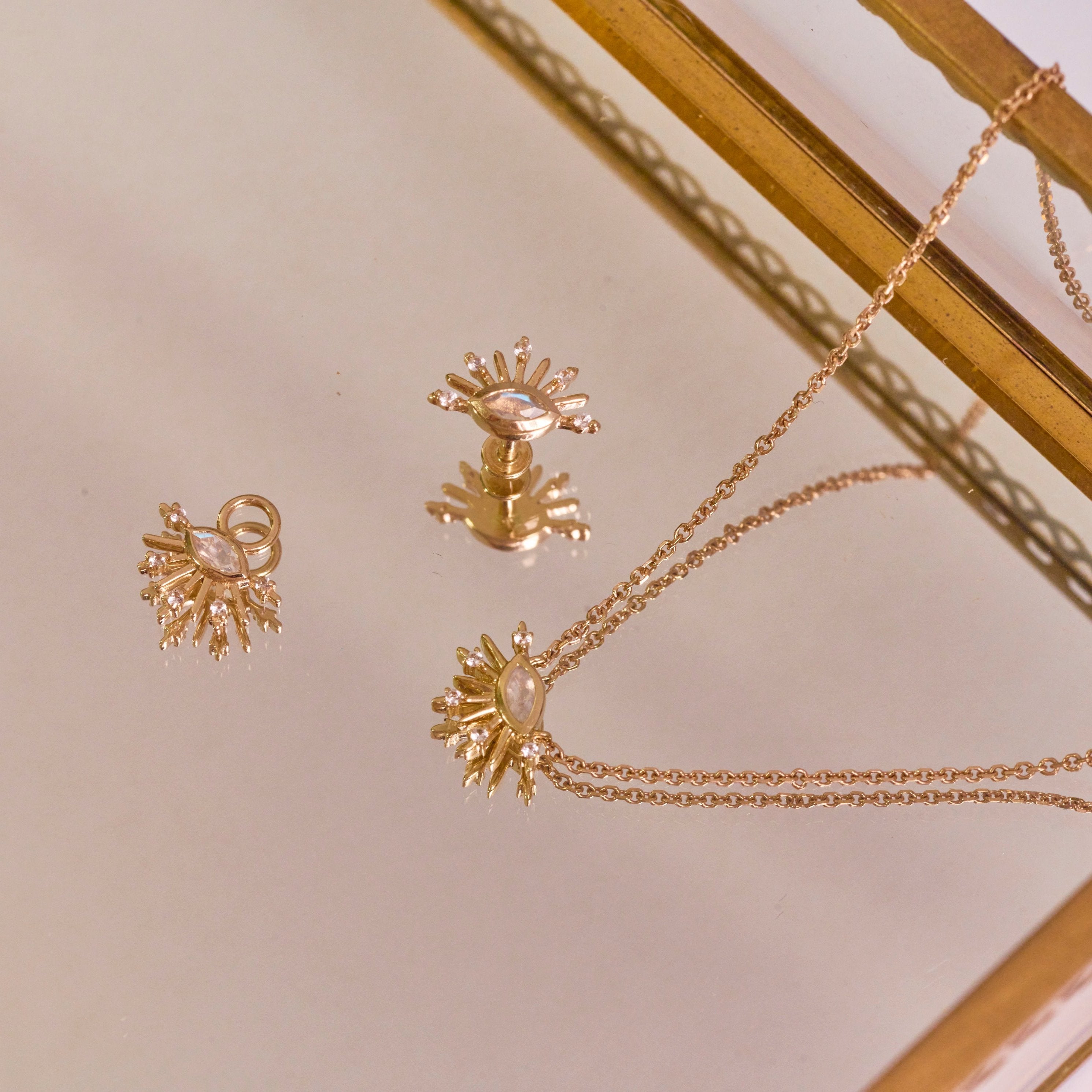 Moonstone & White Sapphire Sunburst 9k Gold collection in mirror jewellery tray