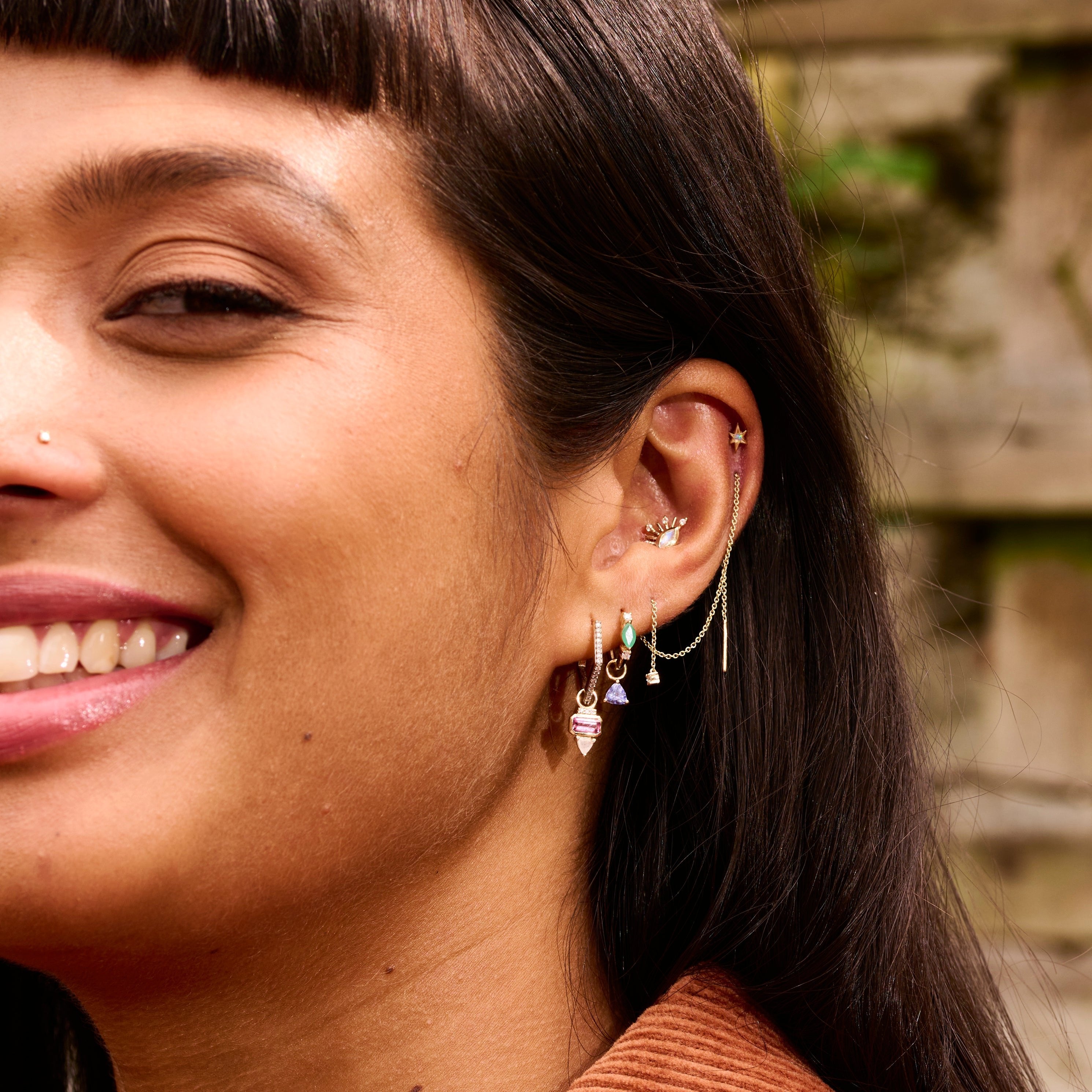 model wearing solid gold ear stack including the Opal Star Flat Back Earring 14k Gold
