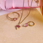 Pink tourmaline and diamond matching set displayed on hard surface including the Pink Tourmaline, Diamond & Moonstone Earring Charm 9k Gold