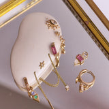solid gold earring pieces displayed including the Pink Tourmaline, Diamond & Moonstone Earring Charm 9k Gold