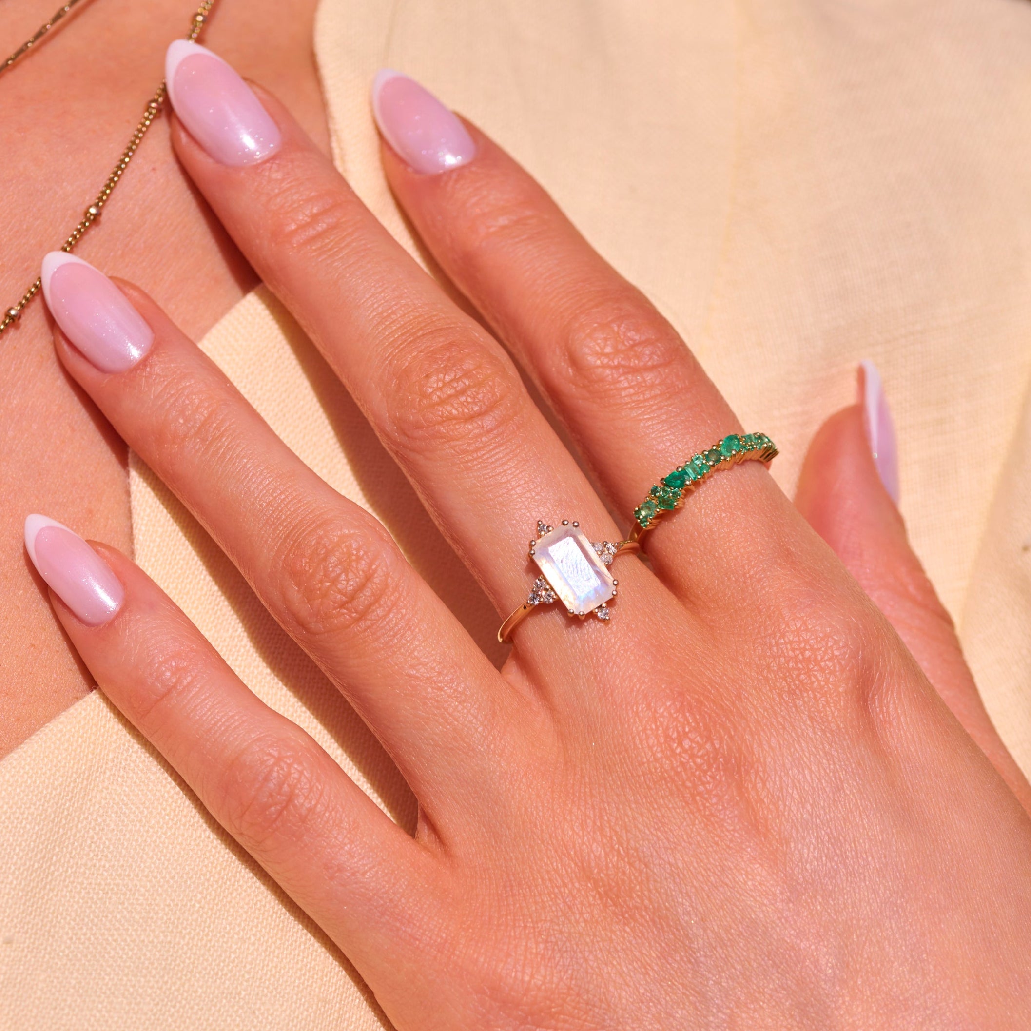 model wearing solid gold rings including the Rectangle Moonstone & Diamond Ring 9k Gold