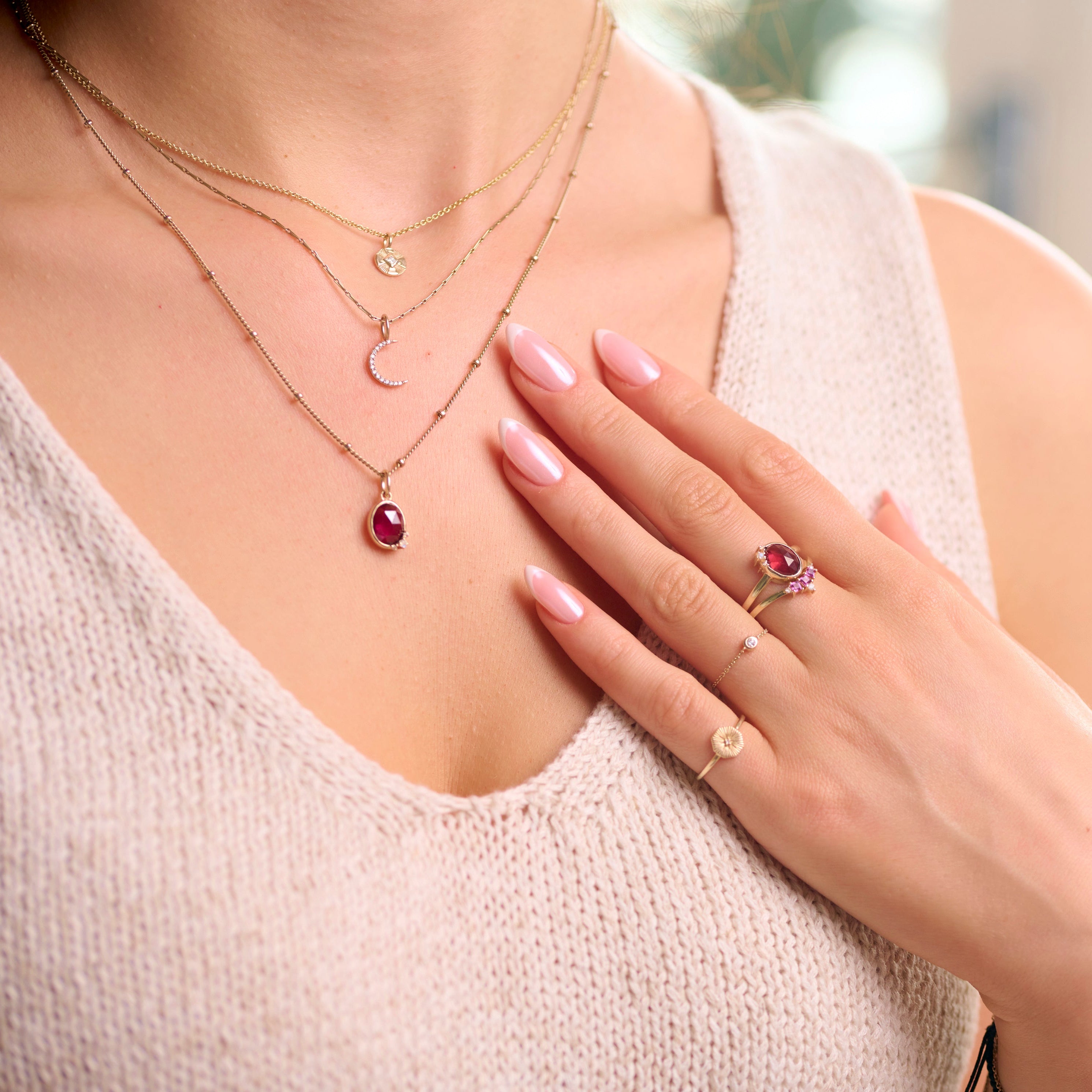 model wearing solid gold pieces including the Rhodolite Garnet, Moonstone & White Sapphire Necklace 9k Gold