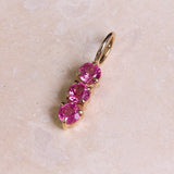 Personalised Birthstone Trio Pendant 9k Gold on hard surface