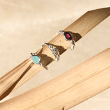 silver gemstone hoops on palm