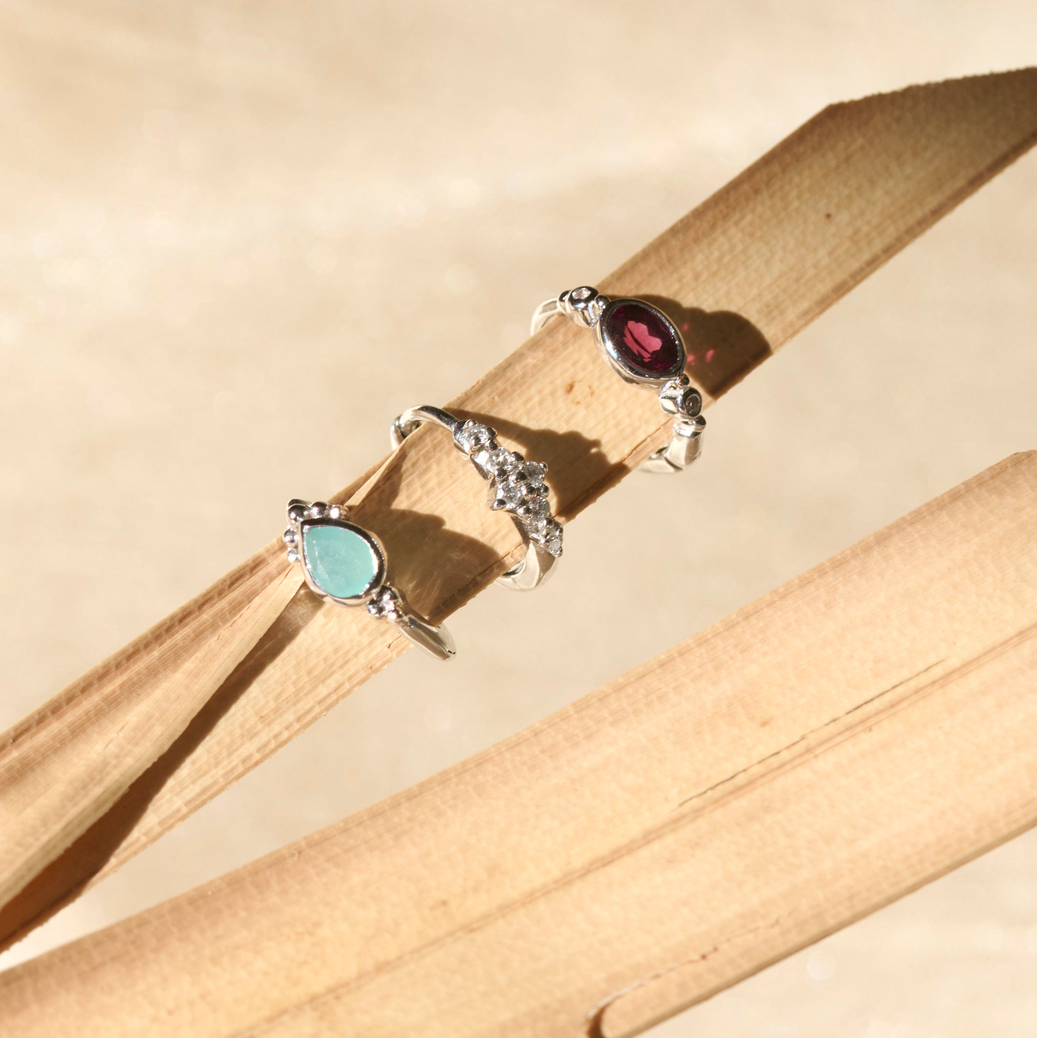 silver gemstone hoops on palm