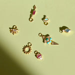gold charms on green surface