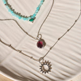 sterling silver necklaces on off white dish