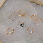 A collection of 6 daith earrings including one london blue topaz 9 karat gold hoop with tanzanite & moonstone