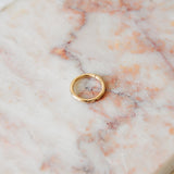 Seamless earring hoop made with 9 karat gold displayed on a pink marble background