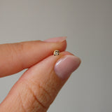 Model holding diamond triangle flat back earring