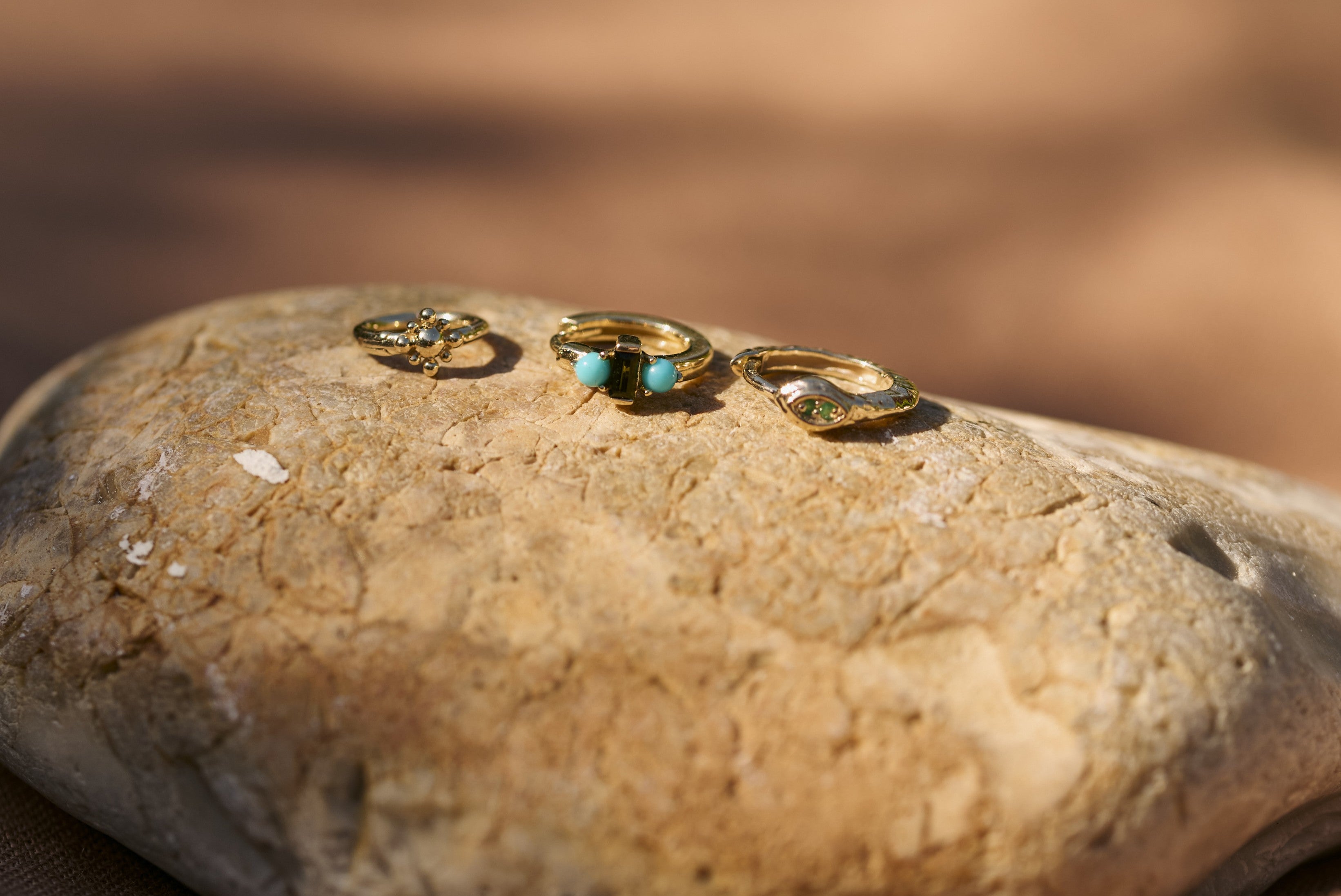 solid gold huggies with turquoise and emerald stones