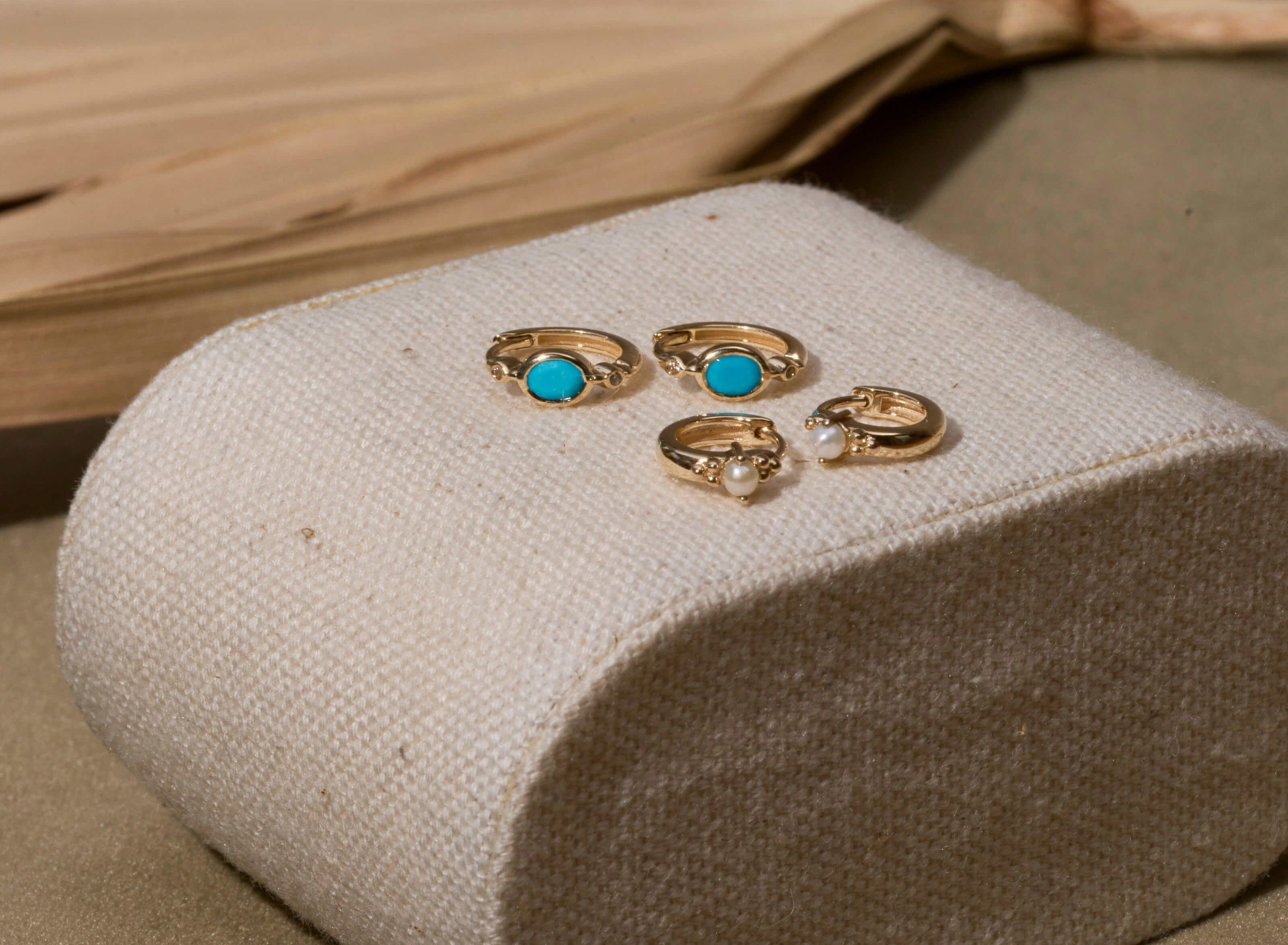 solid gold huggies with turquoise and pearl stones