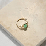 Chrysoprase & Moonstone Ring 9k Gold on hard surface