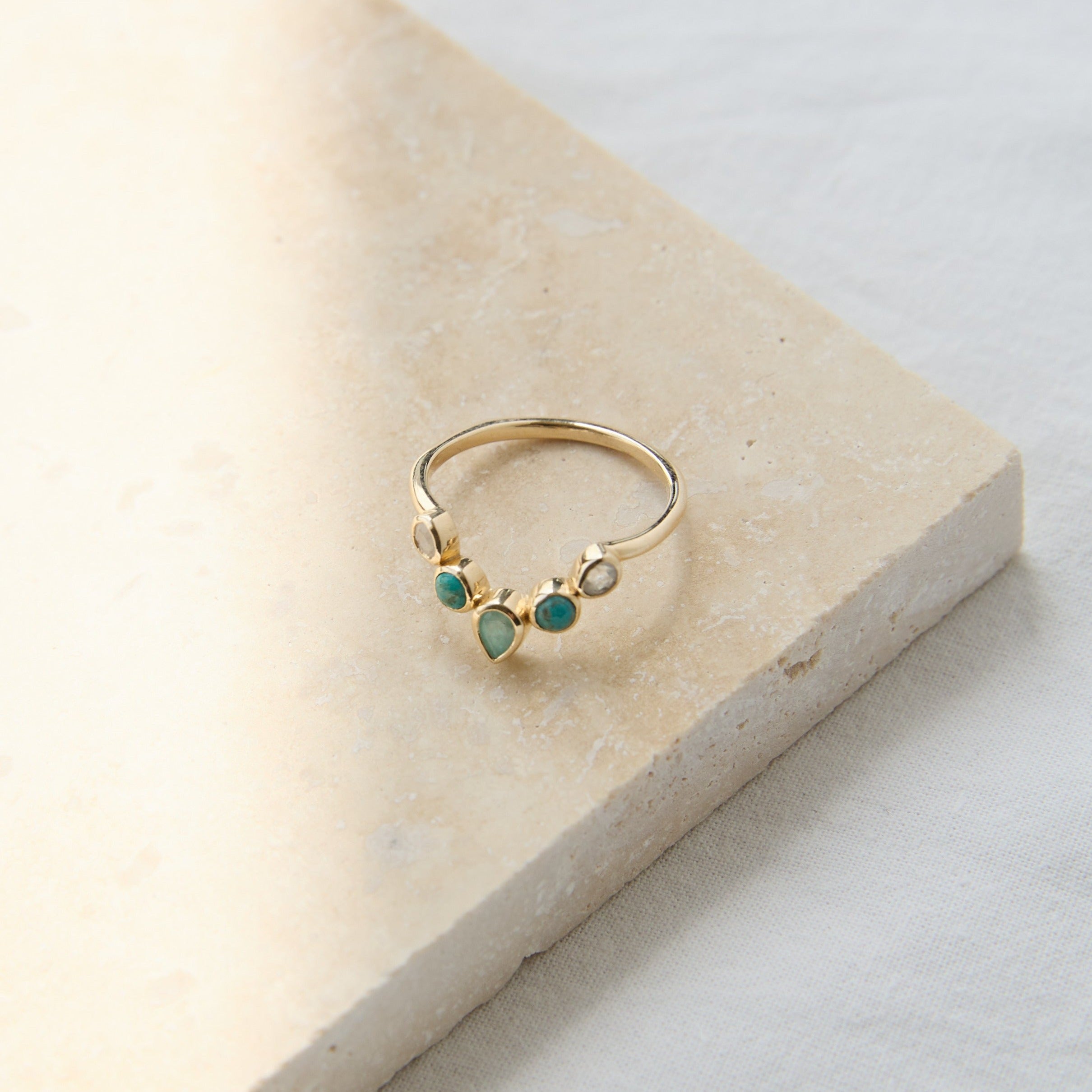 Semi-Precious Stone Hugging Ring 9k Gold on hard surface