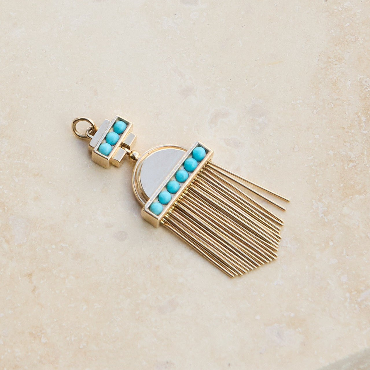 Aztec Turquoise Pendant 9k Gold on hard surface