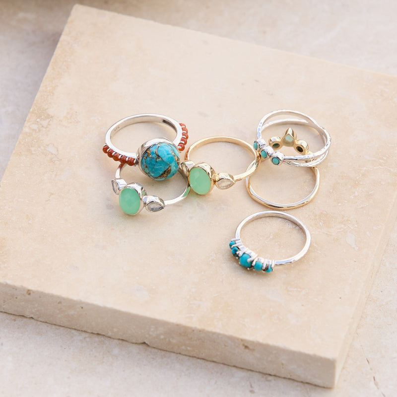 mix metals rings displayed on stone including the Copper Turquoise & Orange Carnelian Ring Sterling Silver
