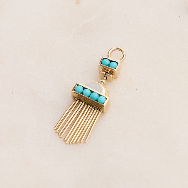 Aztec Turquoise Earring Charm 9k Gold on hard surface