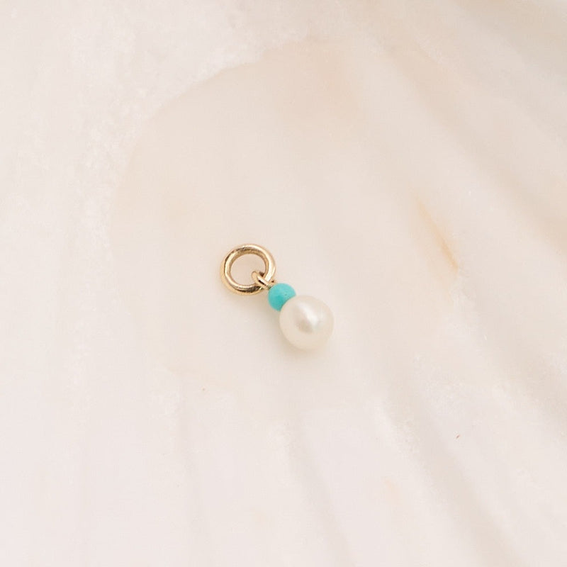 Pearl & Turquoise Earring Charm 9k Gold on hard surface