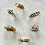 solid gold vintage rings displayed on tile, including the 15 kt Gold Salt & Pepper Diamond Signet Vintage Ring
