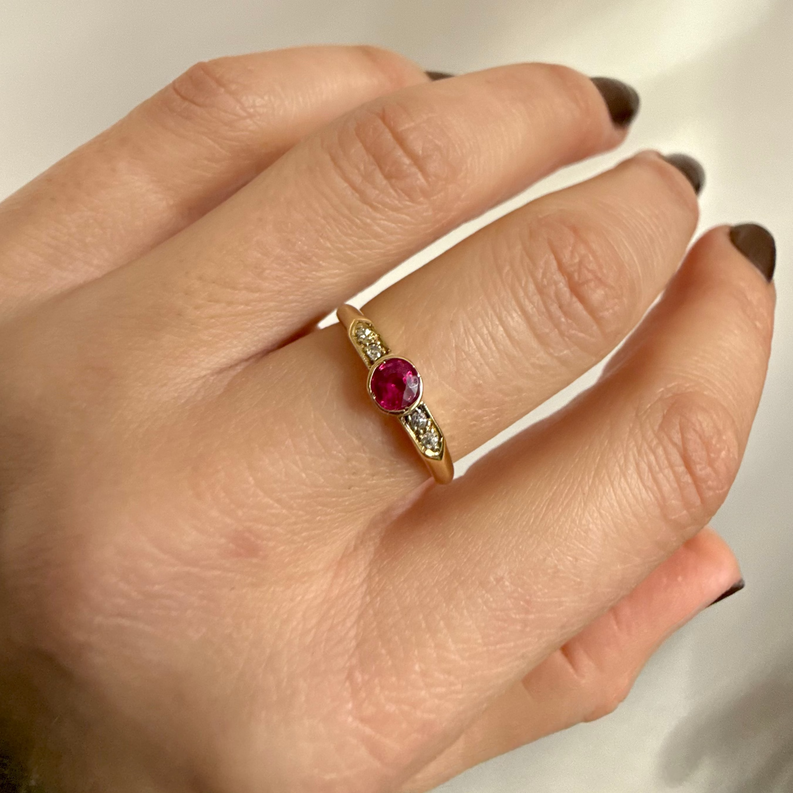 close up of the 15kt Gold Ruby & Diamond Band Vintage Ring on model hand
