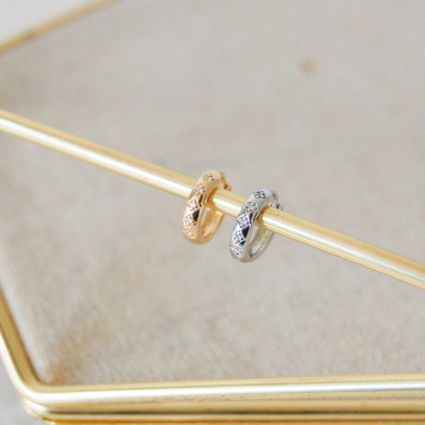 Diamond Engraved Huggie Hoop Earring 9k yellow and white Gold attached to bar of jewellery tray