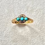 close up of the 9kt Turquoise & Pearl Vintage Ring on hard surface