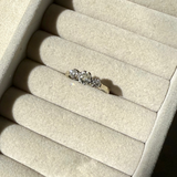Diamond ring on a beige jewelry display