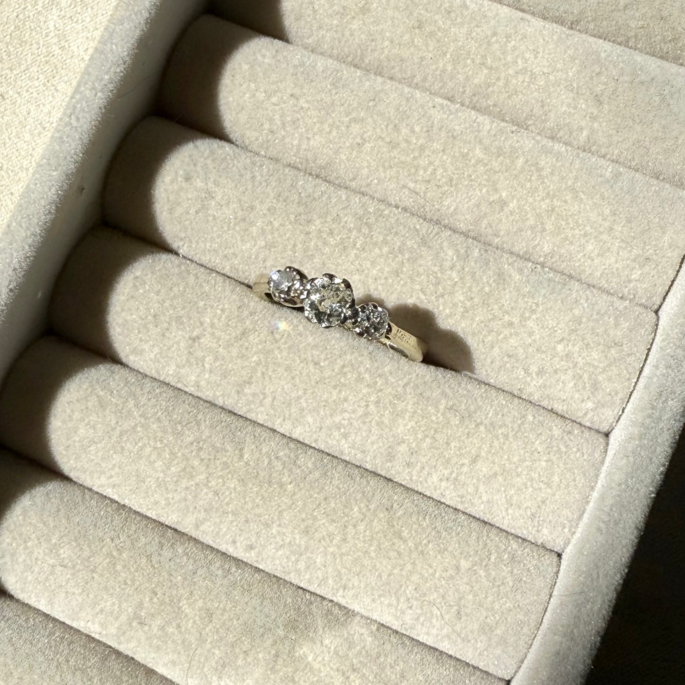 Diamond ring on a beige jewelry display