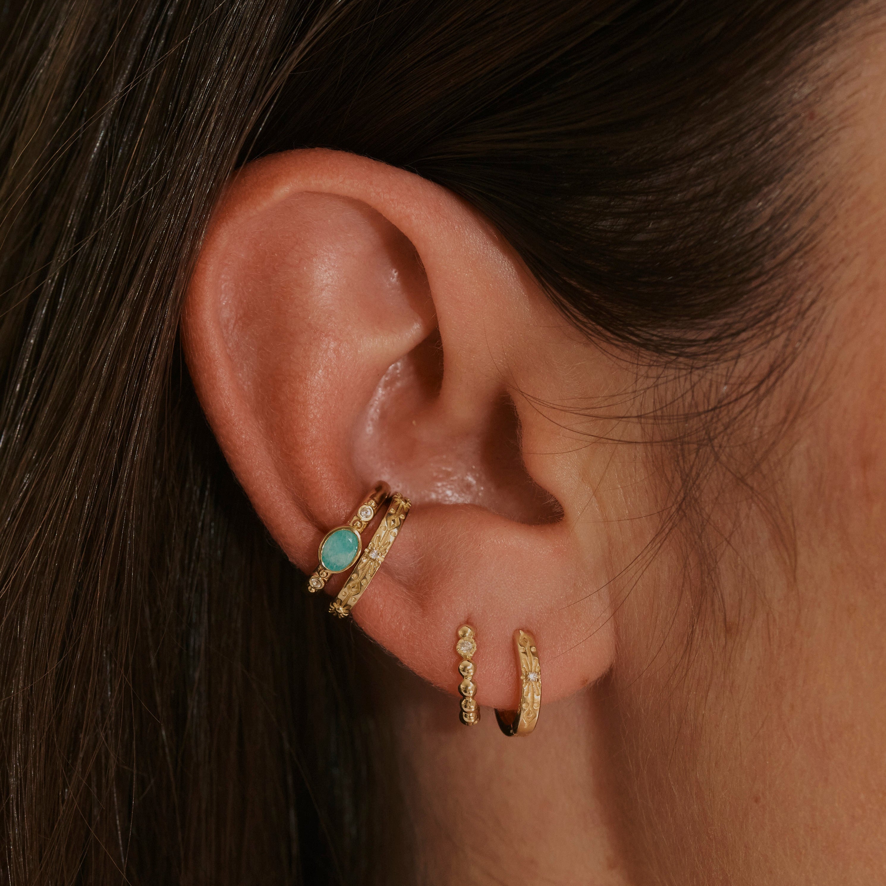 model wearing gold ear stack including the Amazonite & White Sapphire Ear Cuff 14k Gold Vermeil