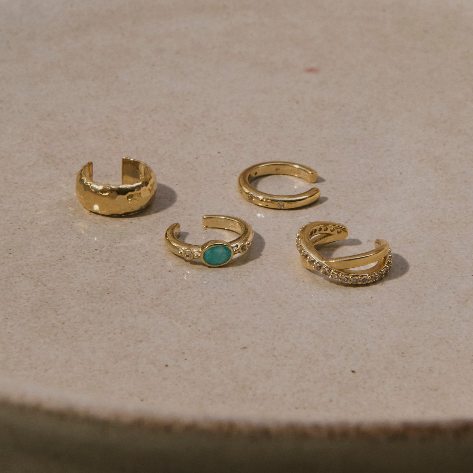 14k gold vermeil ear cuffs in porcelain dish including the Amazonite & White Sapphire Ear Cuff 14k Gold Vermeil


