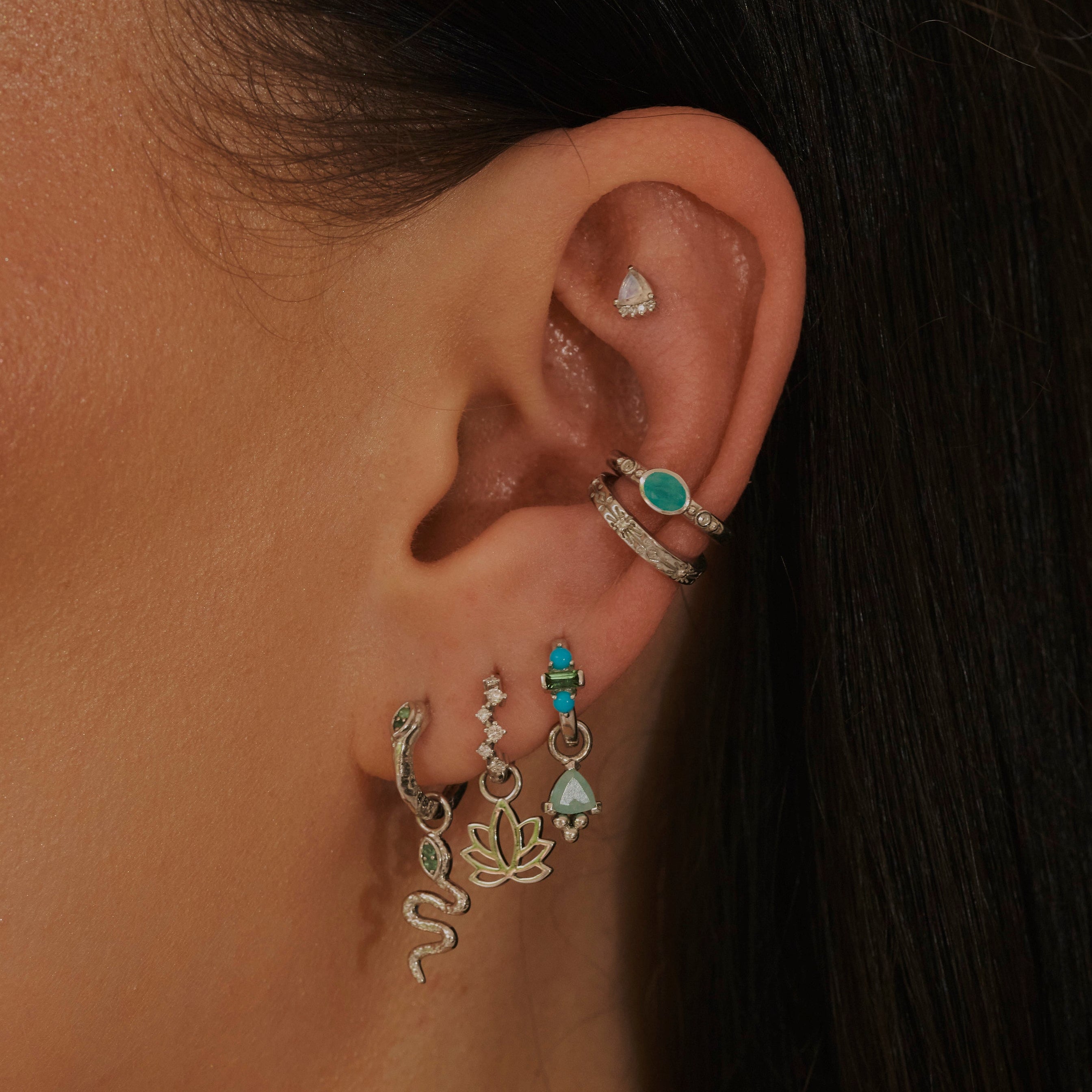 model wearing silver earrings and ear cuffs including the Amazonite & White Sapphire Ear Cuff Sterling Silver