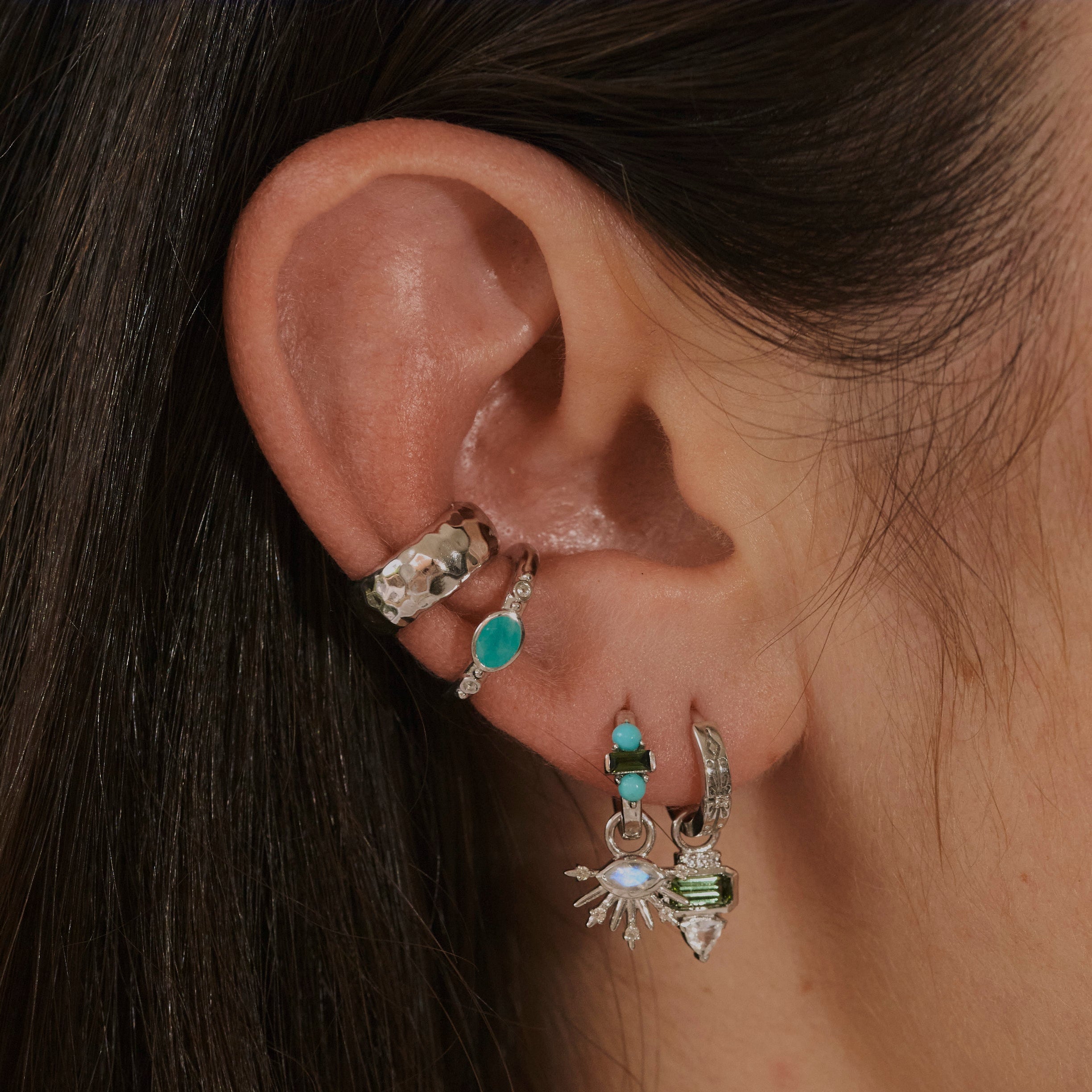 model ear wearing silver earrings including the Amazonite & White Sapphire Ear Cuff Sterling Silver
 and hammered ear cuff