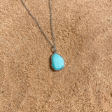Amazonite silver necklace on sand