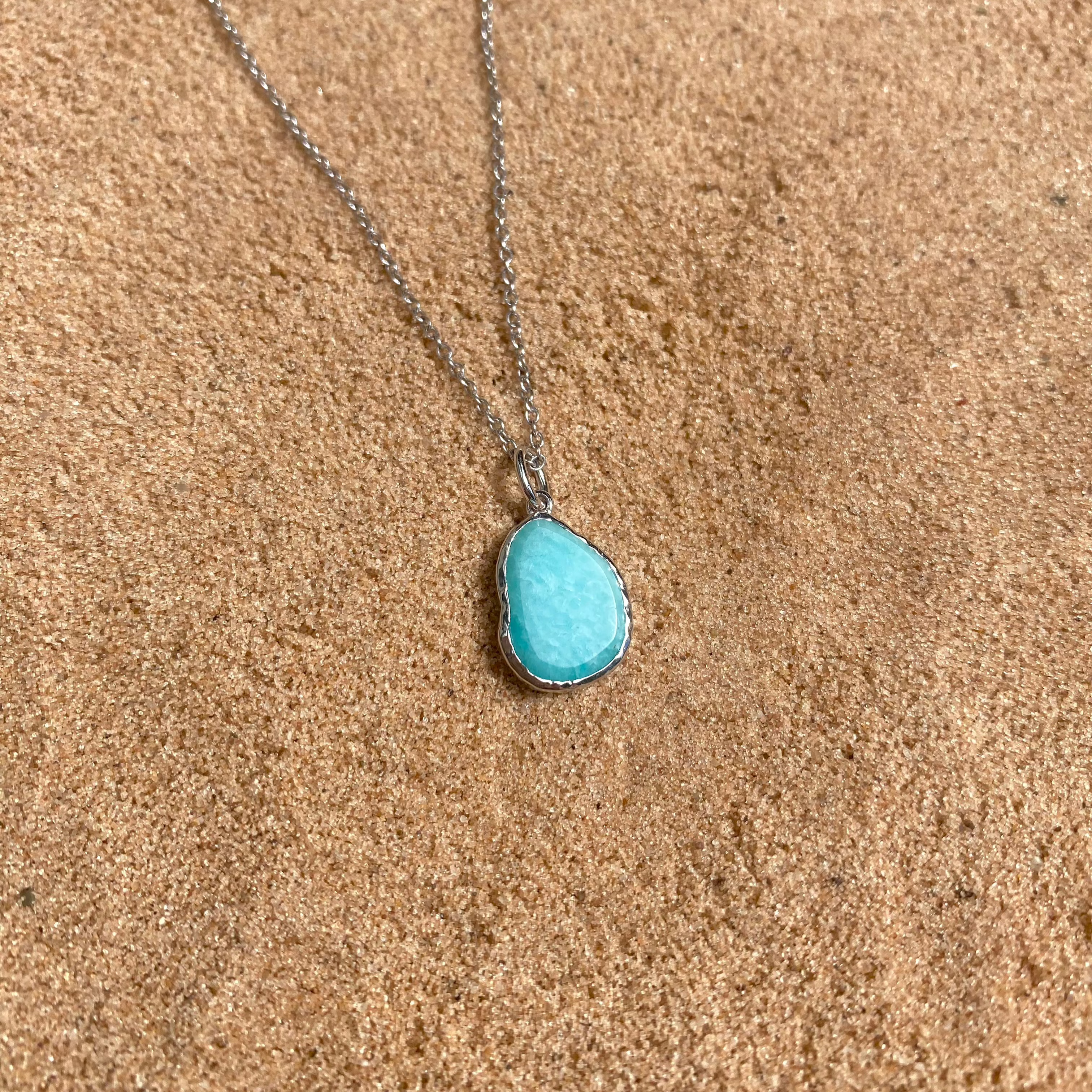 Amazonite silver necklace on sand