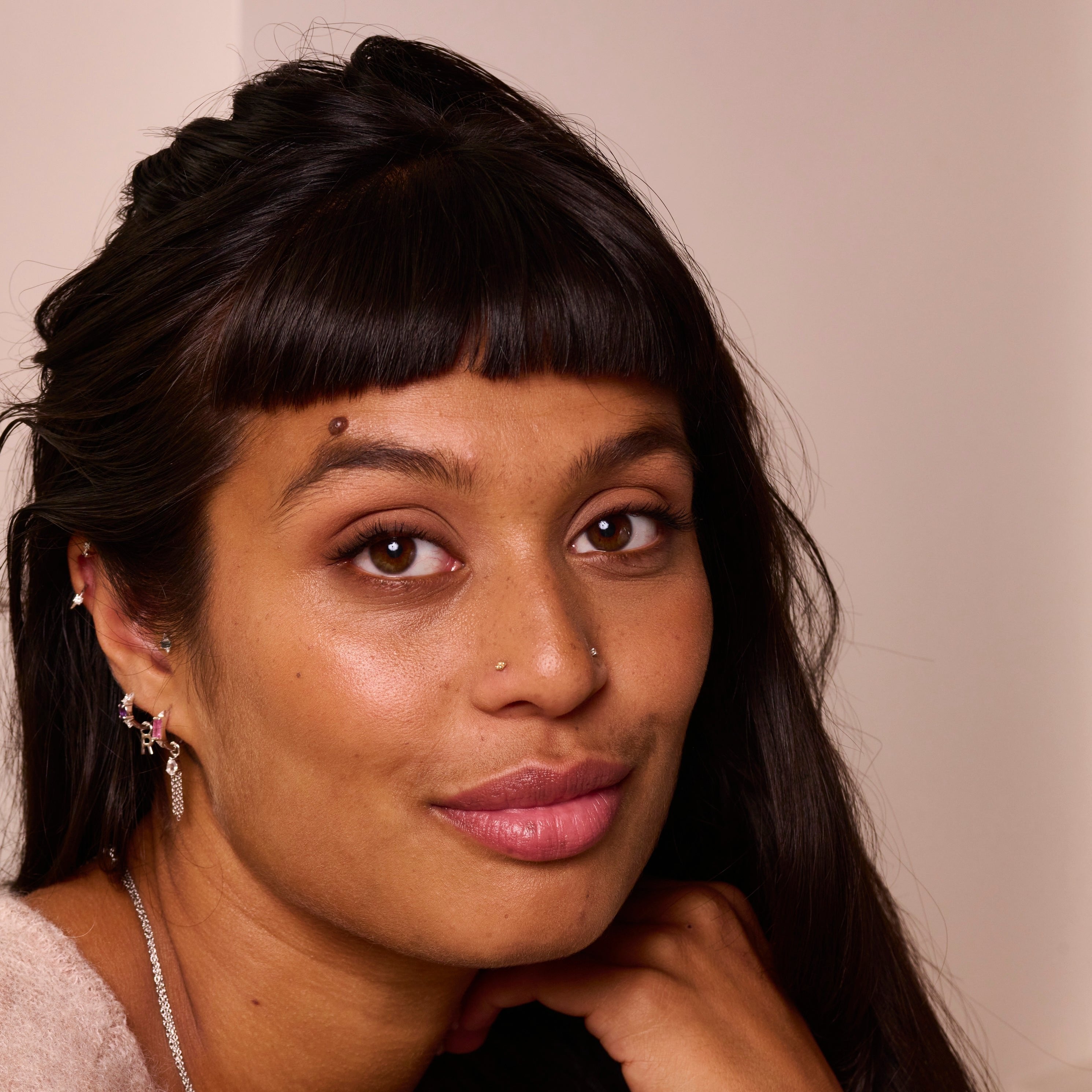 model wearing sterling silver jewellery including the Amethyst & White sapphire Huggie Hoop Earring Sterling Silver